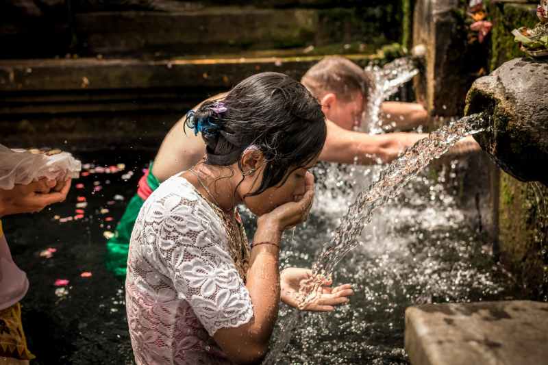 man and woman bathing on running water